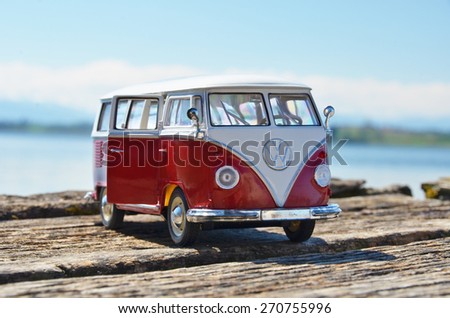 Miniature VW Bulli 1962 on the wooden pier. The cult car of the Hippie generation and it remained the status vehicle of the high wave surfers