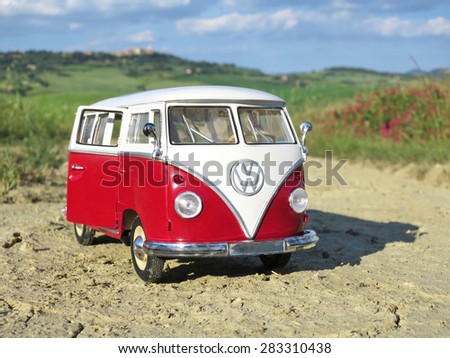 Miniature VW Bulli 1962 on the rural road. The cult car of the Hippie generation and it remained the status vehicle of the high wave surfers.