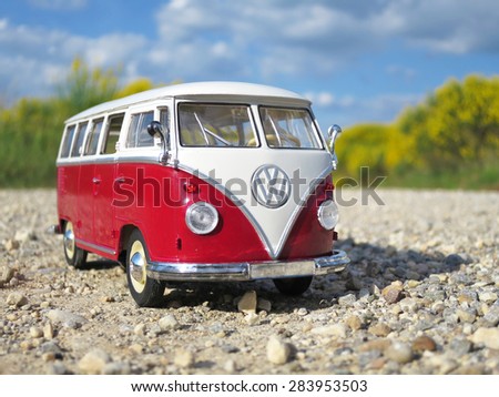 ALSACE, FRANCE - MAY 29, 2015:Miniature VW Bulli 1962 on the rural road. The cult car of the Hippie generation and it remained the status vehicle of the high wave surfers.