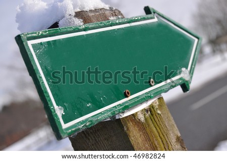 Empty road sign covered with snow
