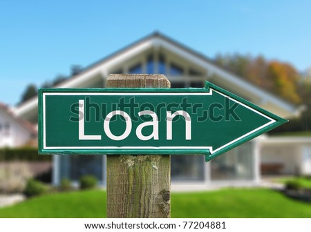 LOAN sign against a house
