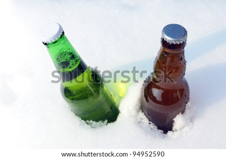 Two beer bottles in the snow