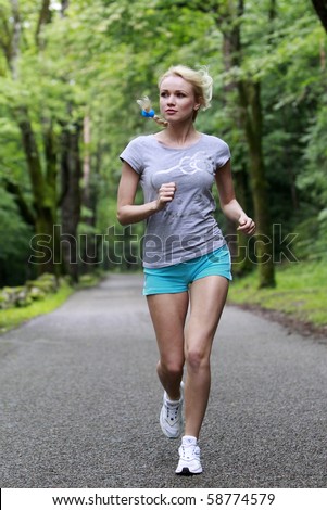 Young Blond girl running on the road.