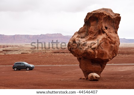 Bizarre Balanced Rock Dwarfs a Car near Lees Ferry, Marble Canyon, Glen Canyon National Recreation Area, Arizona, USA