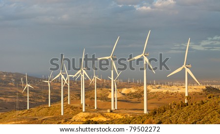 Windmills at Tehachapi Pass Wind Farm, California, generating clean renewable electrical energy without carbon dioxide emissions to fight climate change and global warming.