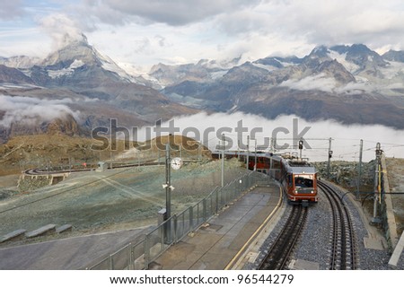 The Gornergratbahn, a narrow gauge mountain rack railway, approaching the Gornergrat summit station. Matterhorn in the background.