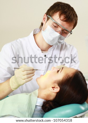 Young woman with dentist in a dental surgery. Healthcare, medicine.
