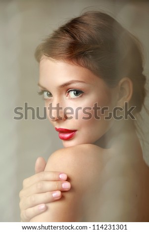 A beautiful woman portrait isolated on grey background A beautiful woman portrait isolated on grey background