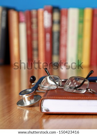 Stethoscope on book with leather cover