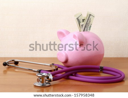 Piggy bank with stethoscope isolated on white concept for financial checkup or saving for medical insurance costs