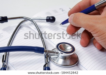Hand with pen over blank Prescription form with patient information