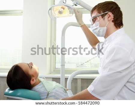Young woman with dentist in a dental surgery. Healthcare, medicine