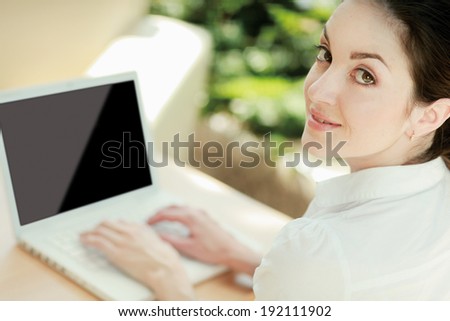 Beautiful woman sitting on the sofa with laptop