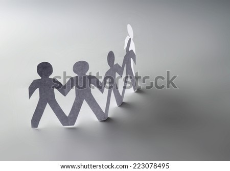 White paper people standing in a cycle and one orange paper man inside. Isolated on white background