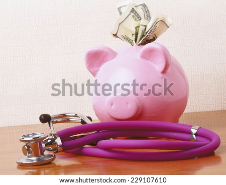 Piggy bank with stethoscope isolated on white concept for financial checkup or saving for medical insurance costs