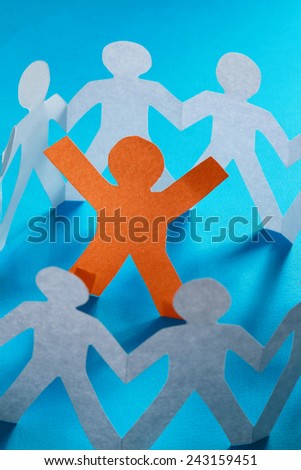 A circle of paper cutted people with clipping path on blue