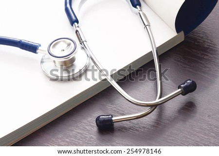 A blue stethoscope on a writing pad