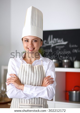 Chef woman portrait with  uniform in the kitchen