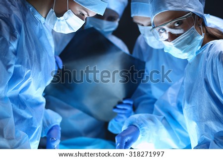 Shot of surgeons working on a patient in an operating room.
