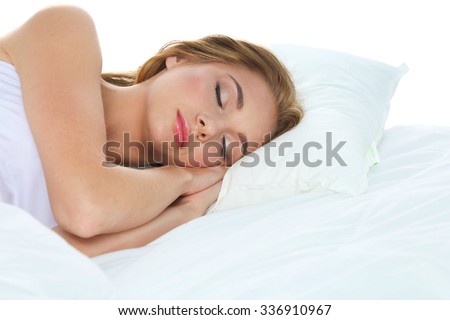 Shot of a young woman sleeping on a bed .