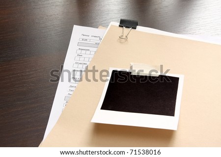 Blank instant print clipped to manila folder
