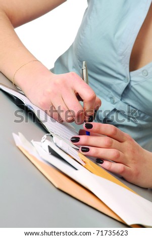 pen in hand writing on the white page with reflection
