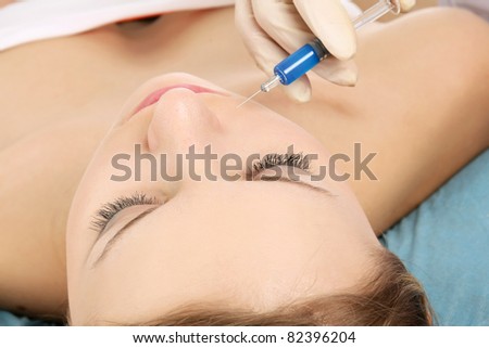 An injection to a woman's face, close-up
