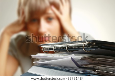 Stressed Out Worker At Her Desk With Files On White Isolated Background