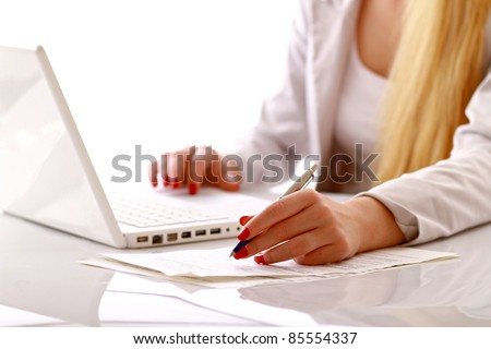Closeup portrait of a young woman in front of a laptop, isolated on white
