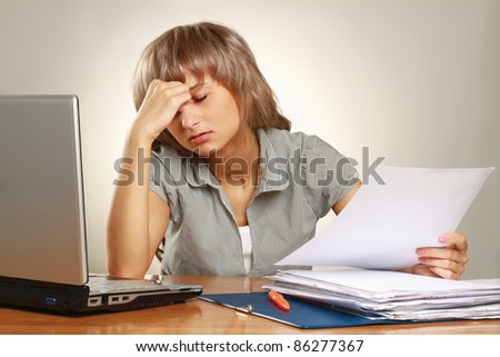 Overworked businesswoman isolated on grey