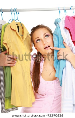 Stylish young girl trying on clothes in clothing store isolated