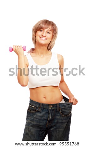 Closeup of a young woman showing how much she lost with dumbbell, isolated on white background