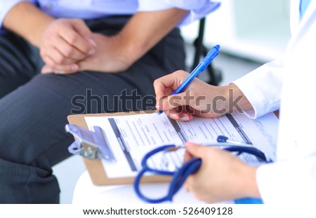 Doctor woman sitting with male patient at the desk