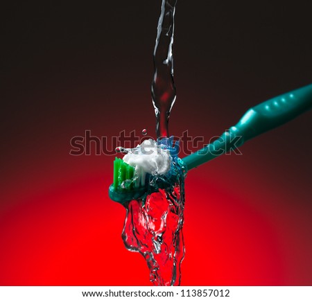 Toothbrush under stream of water