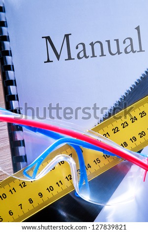 Ruler, manual, handsaw and goggles