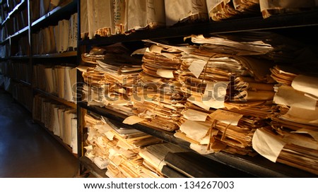 Paper documents stacked in archive