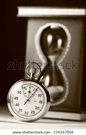 Stopwatch and sand watch in sepia
