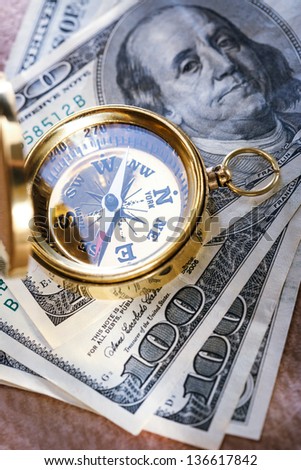 Golden vintage compass and money