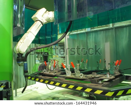 Working welding robot in factory