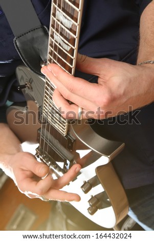Electric guitar in male hands