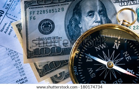 Annual budget, compass, tax form and dollar