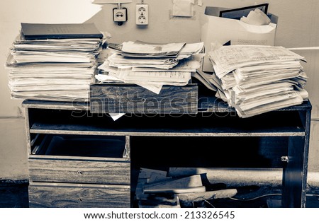 Messy workplace with stack of paper