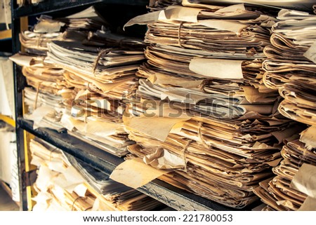 Paper documents stacked in archive