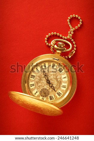 Pocket vintage watch with chain on red