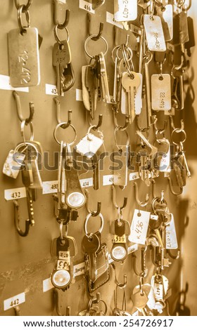 Office room keys with tags hanging on wooden board