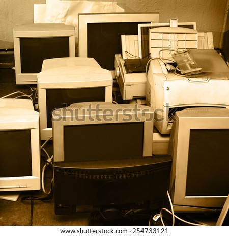 Old computer monitors gathered on the floor