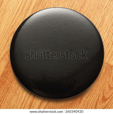 Blank single black round badge in closeup