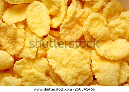 Yellow corn flakes cereal background in closeup