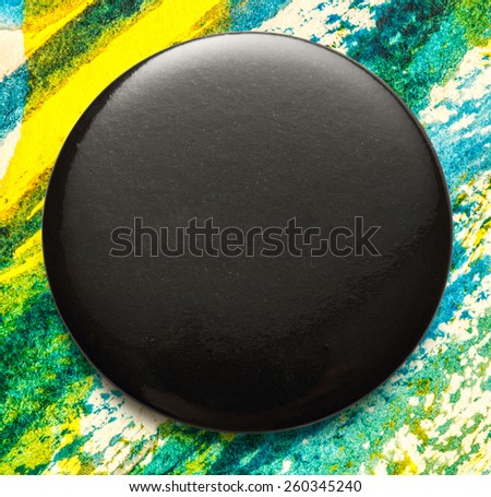 Blank single black round badge in closeup