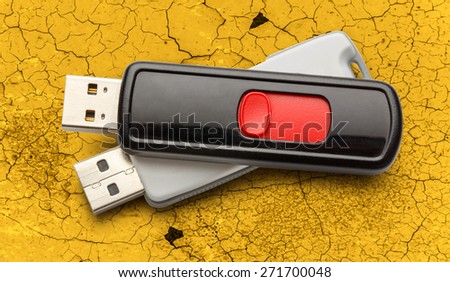 Usb flash drives on the cracked background
